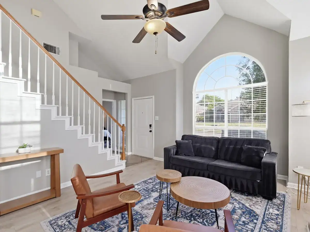 A furnished living room, warm oak styling